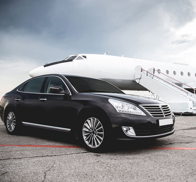 Stretch Limo standing in front of a private jet ready for airport car service